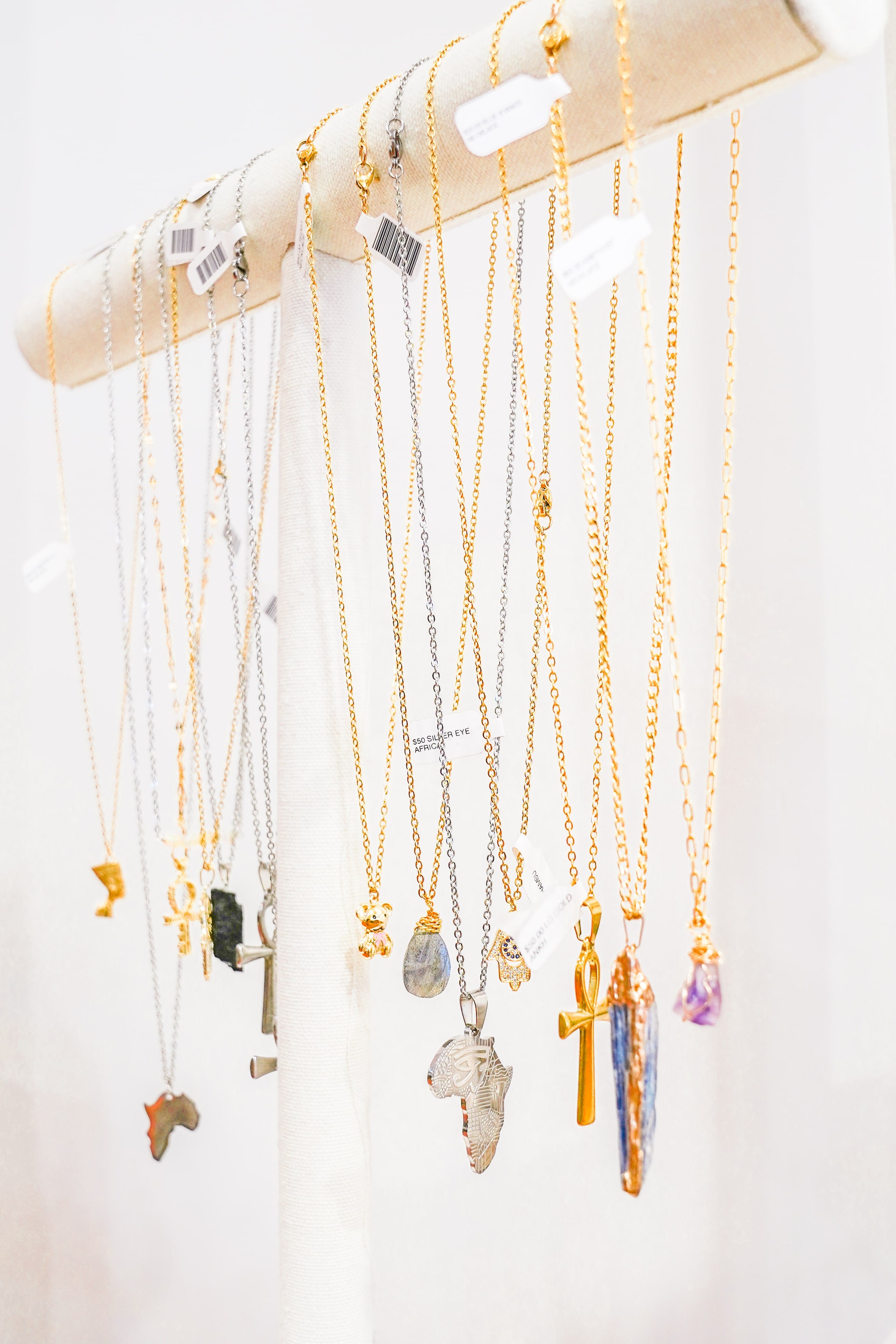 a group of necklaces on a pole