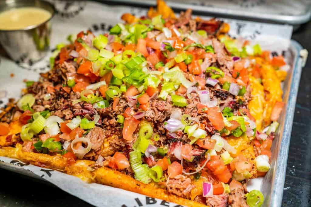 French fries smothered with brisket, cheese, bacon, ranch, and pico de gallo