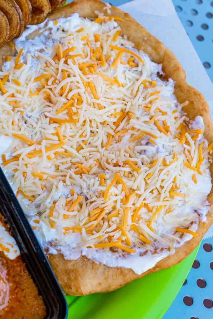 Hungarian Fried Bread topped with sour cream and shredded cheese