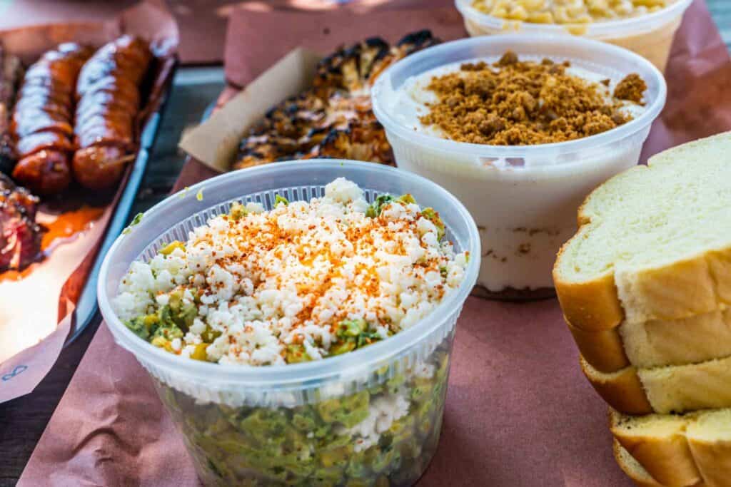 Corn salad, bread pudding, mac and cheese, and cauliflower steak from Helberg BBQ