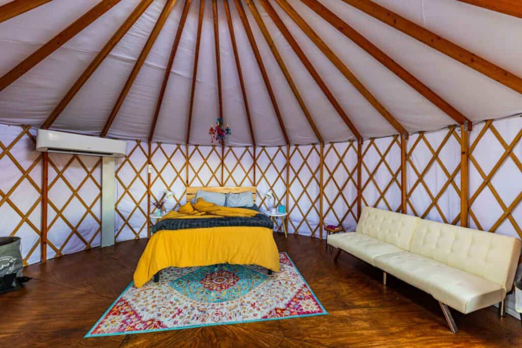 Glamping Tent Interior with Queen Size Bed and Sofa