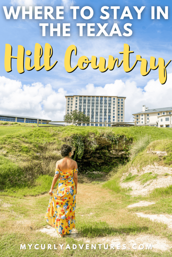 Lady back shot posing at the grasslands with Resort Building View