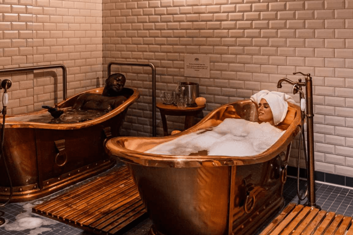 Couple soaking in a beer spa tub