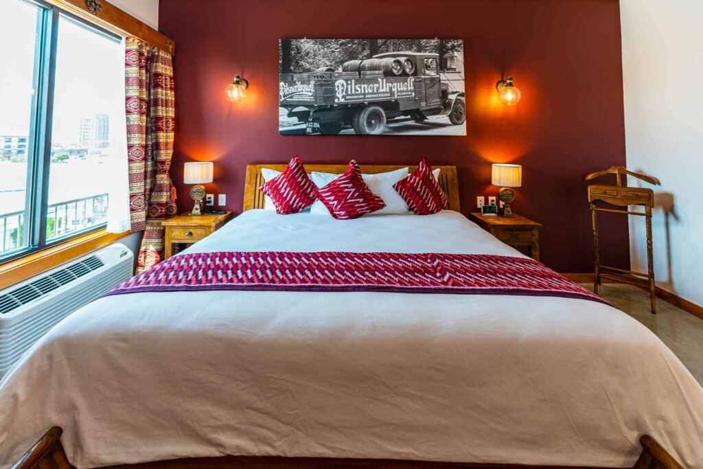 A cozy bed adorned with red and white pillows