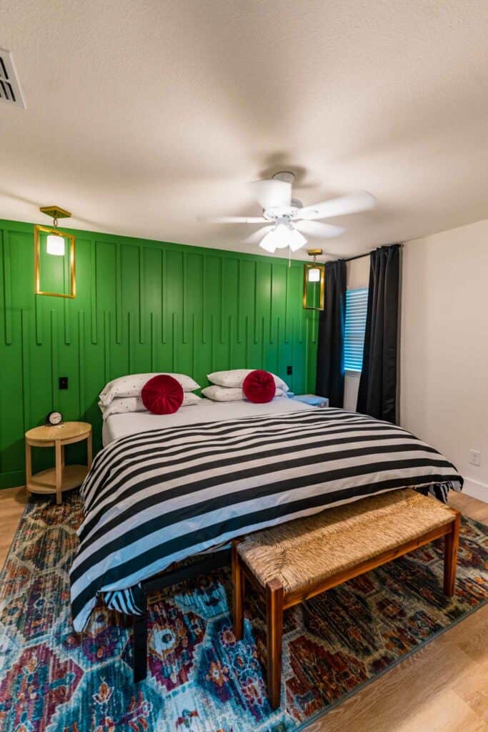 A cozy bedroom featuring green walls 