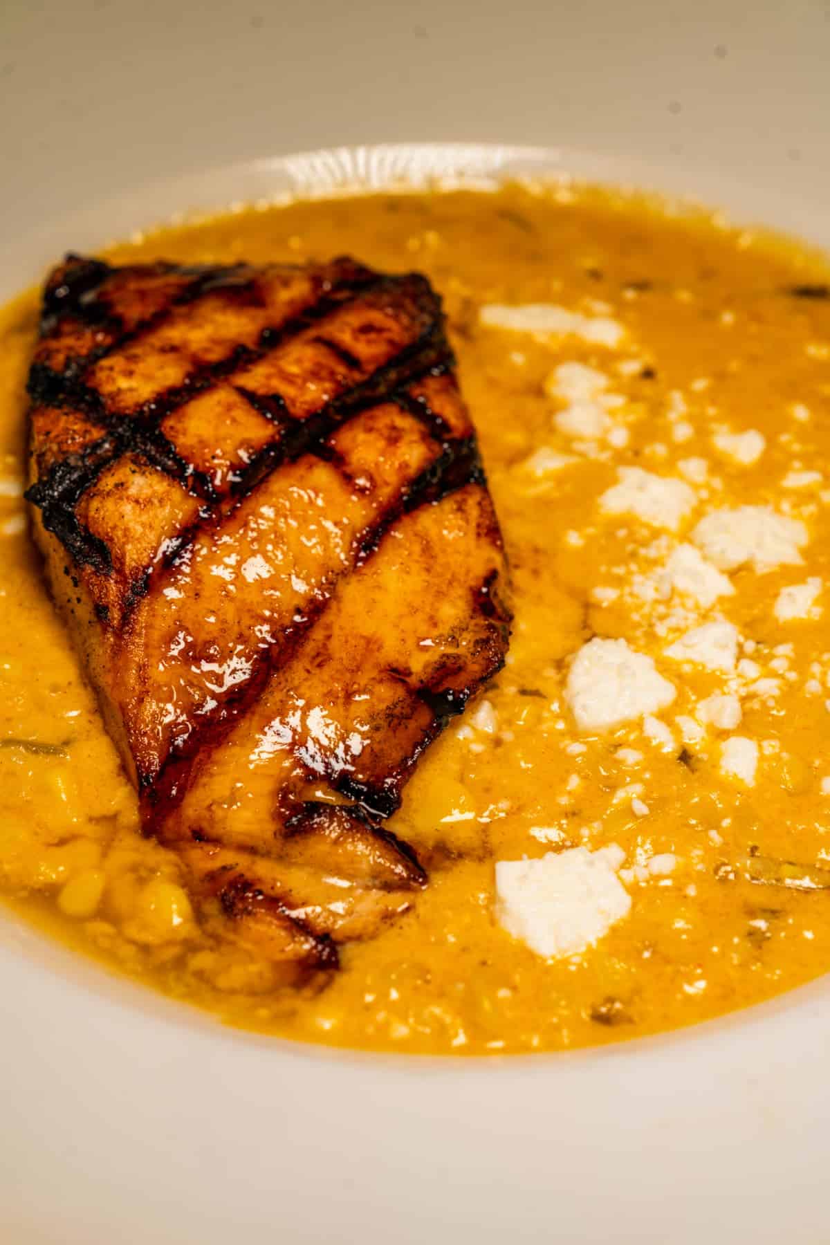 Salmon served with elote style cream corn