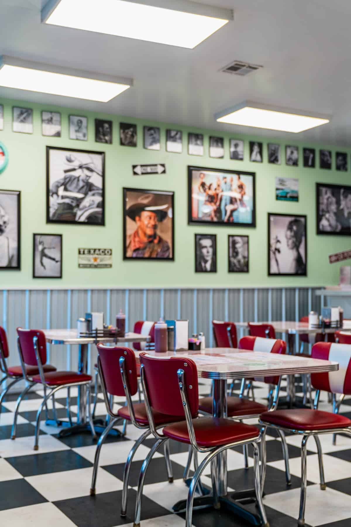 Retro tables and chairs with framed photos on the wall