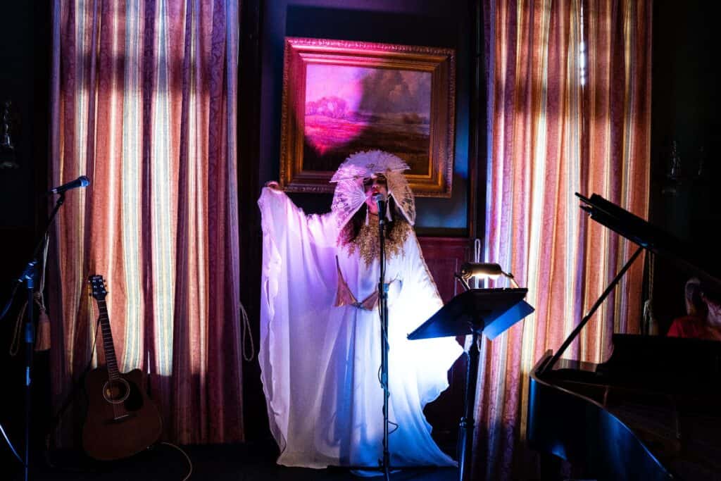 Woman singing in a flowing white dress