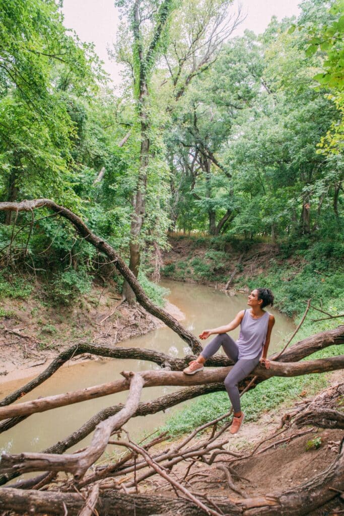 Woman resting on a huge tree branch