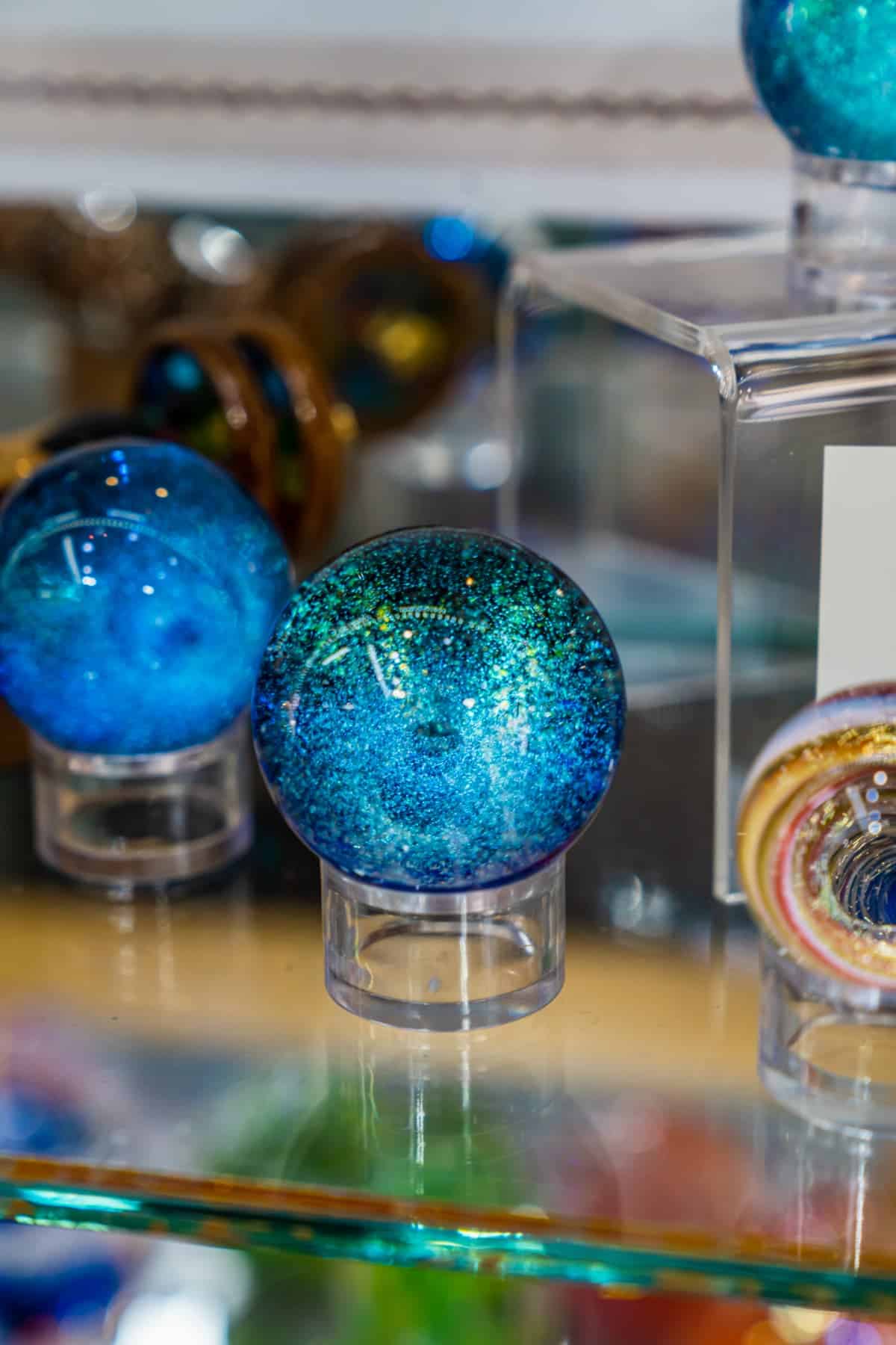 Glittery glass paperweights on display