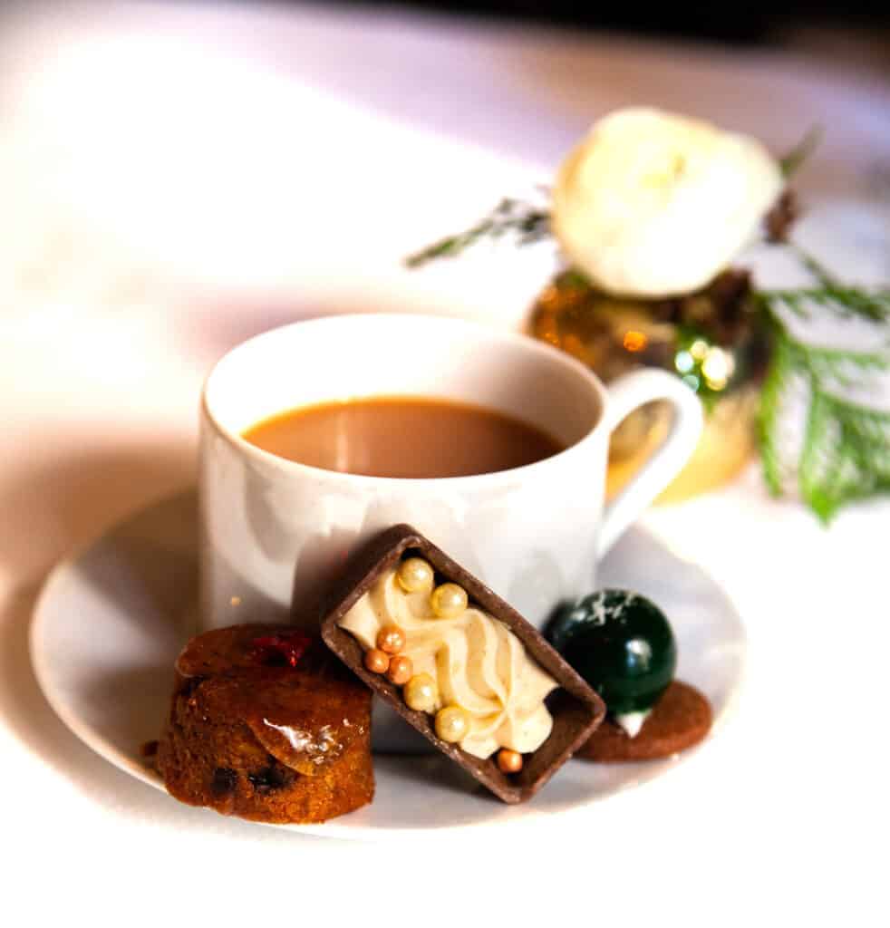 a cup of coffee and dessert on a plate