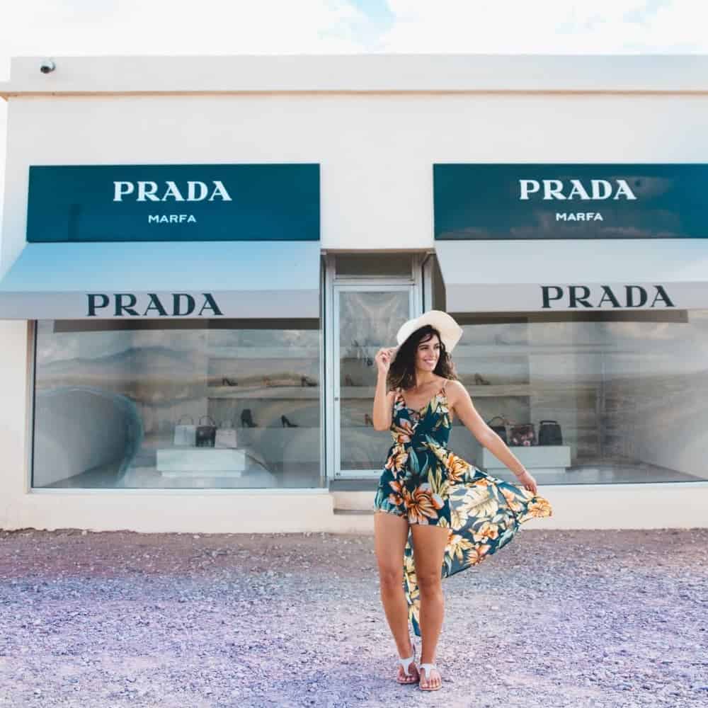 Woman standing in front of abandoned Prada storefront