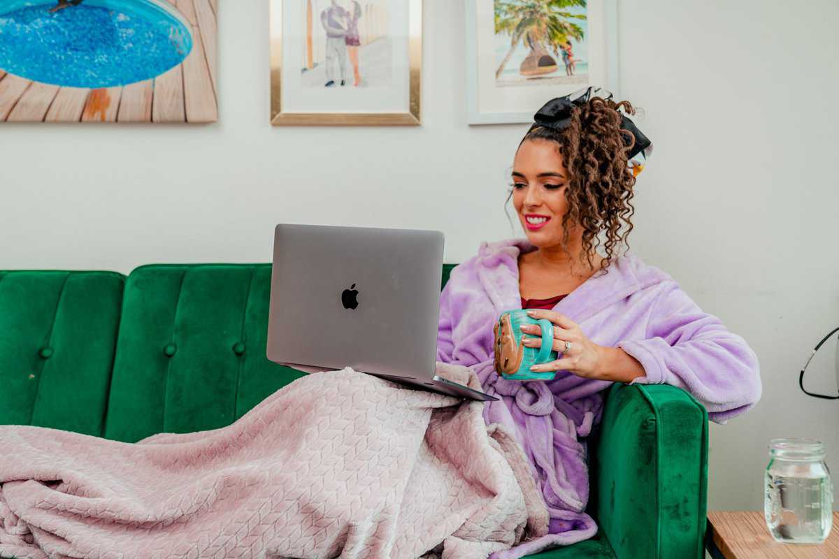  A woman in a purple robe sits on a couch