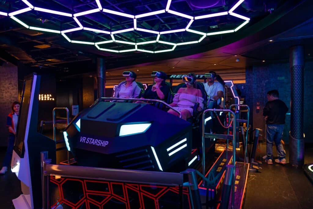 VR rollercoaster with riders inside of it wearing goggles