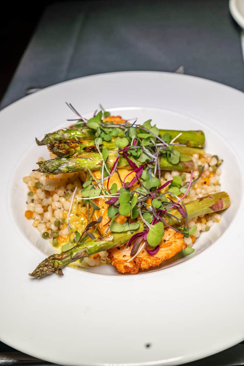 Plate of cous cous, asparagus and bean sprouts