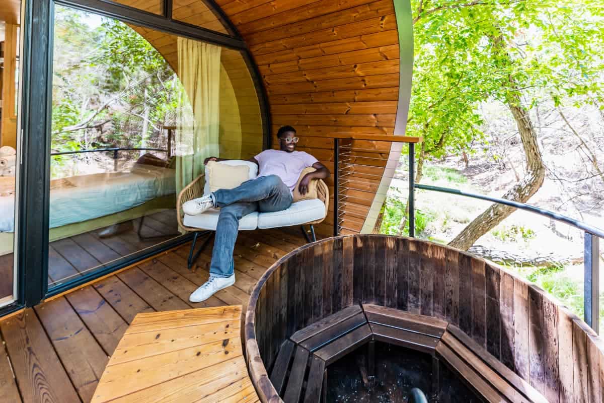 Man sitting in a chair by the outdoor hot tub of the Spyglass