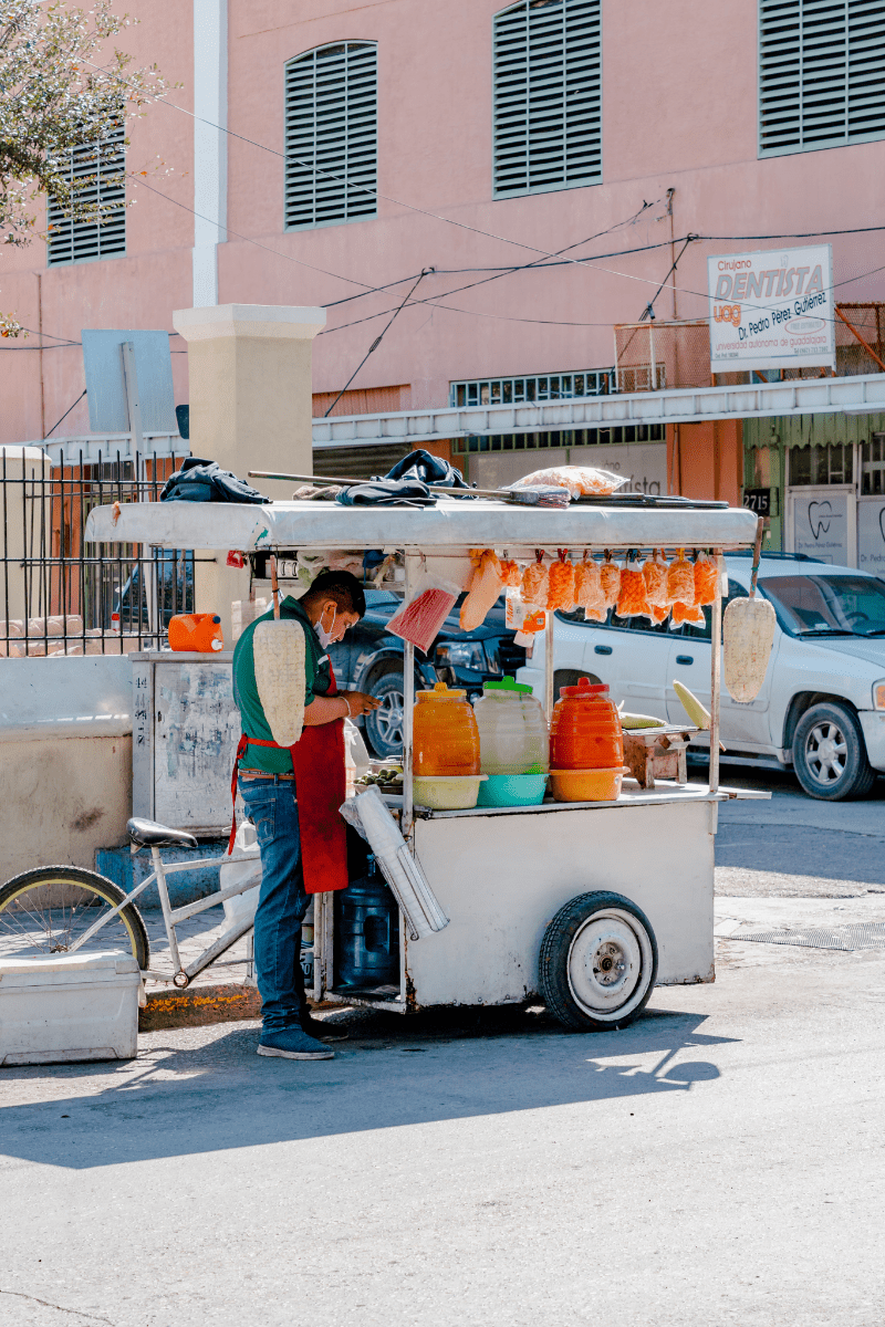 Vendor standing by his cart