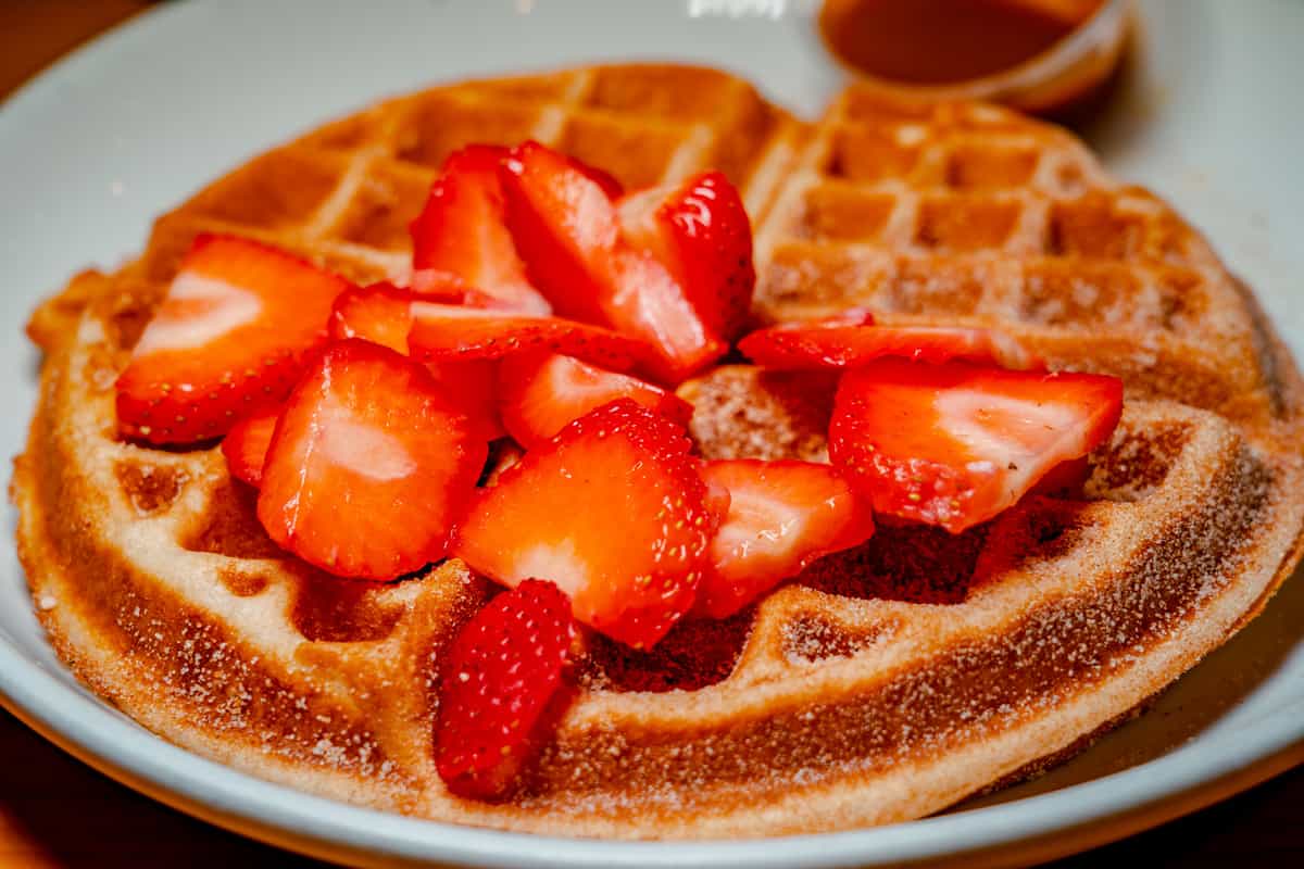 Waffles topped with fresh strawberries