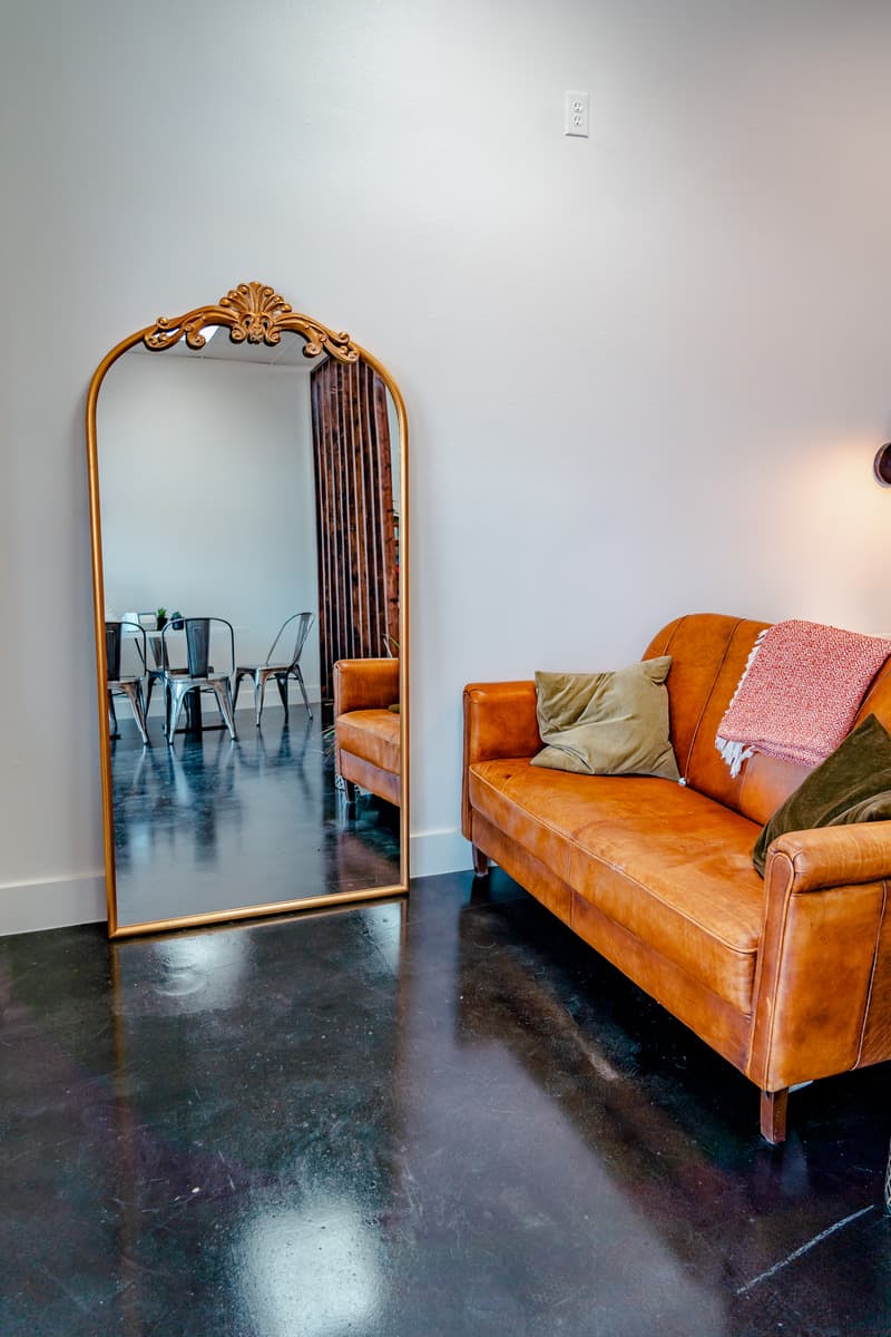 Standing mirror and a leather couch