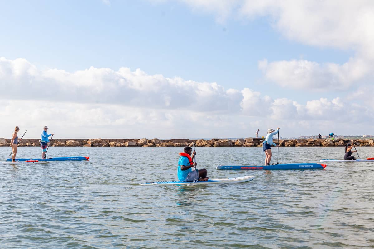 Several people stand-up paddleboarding 