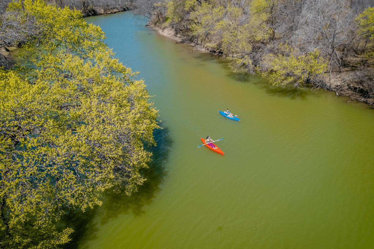 Bird's eye view of two people kayaking on Pecan Bayou Train