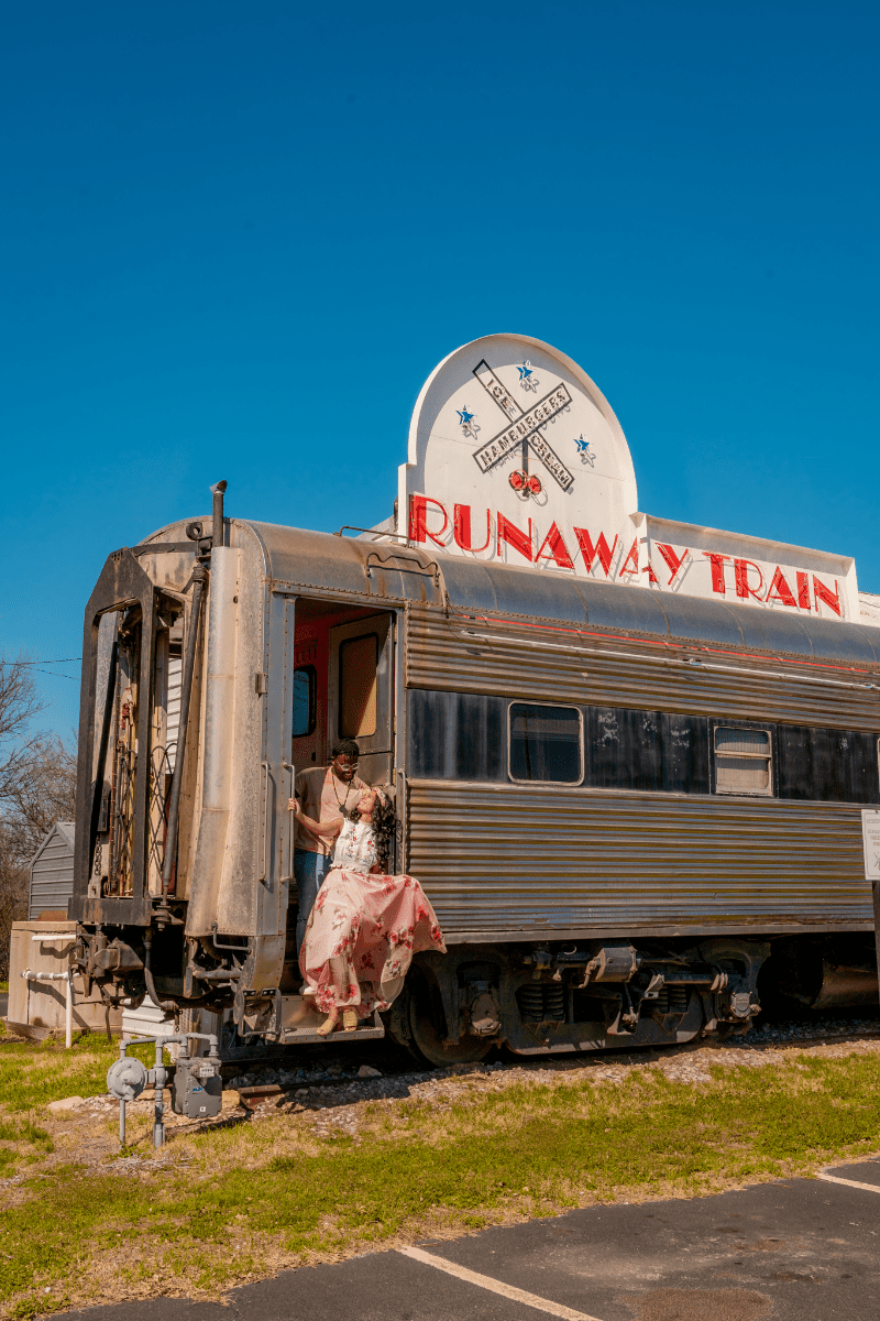 Couple posing at the entrance of Train Cafe