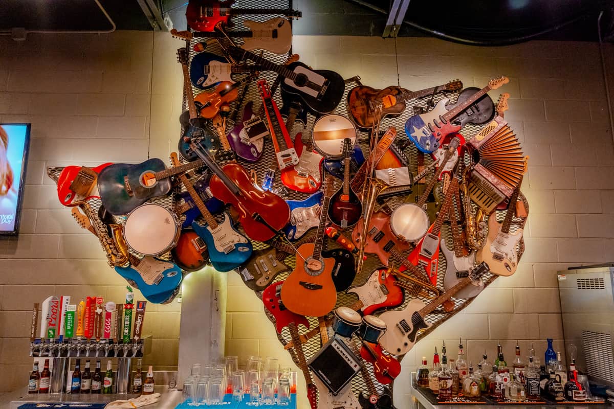 Sculpture of guitars and other instruments behind the bar