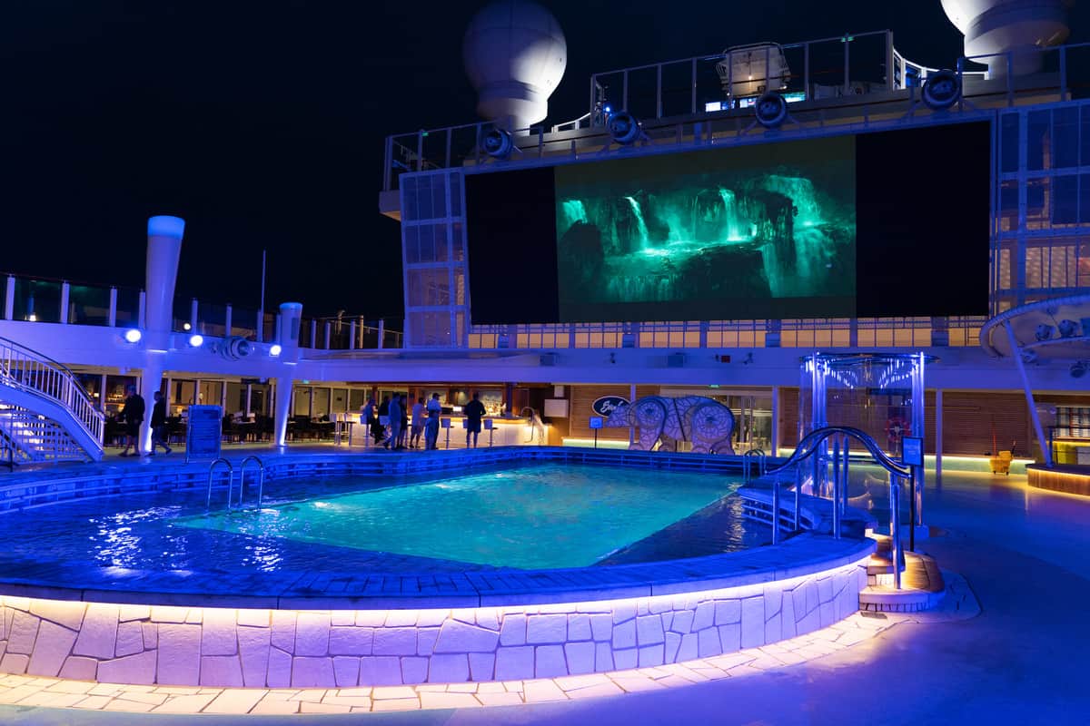 Movie streaming at Vibe Beach Club at night on the norwegian bliss ship