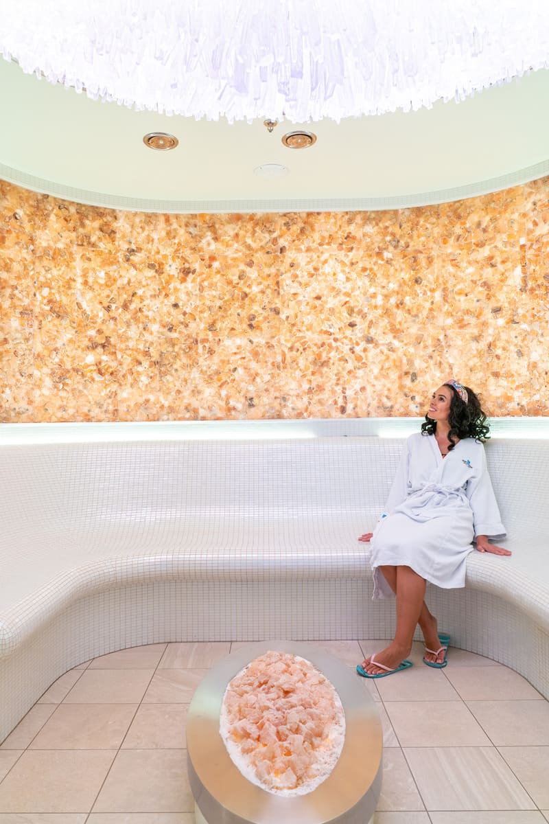 Woman sitting inside a Salt Room at a spa