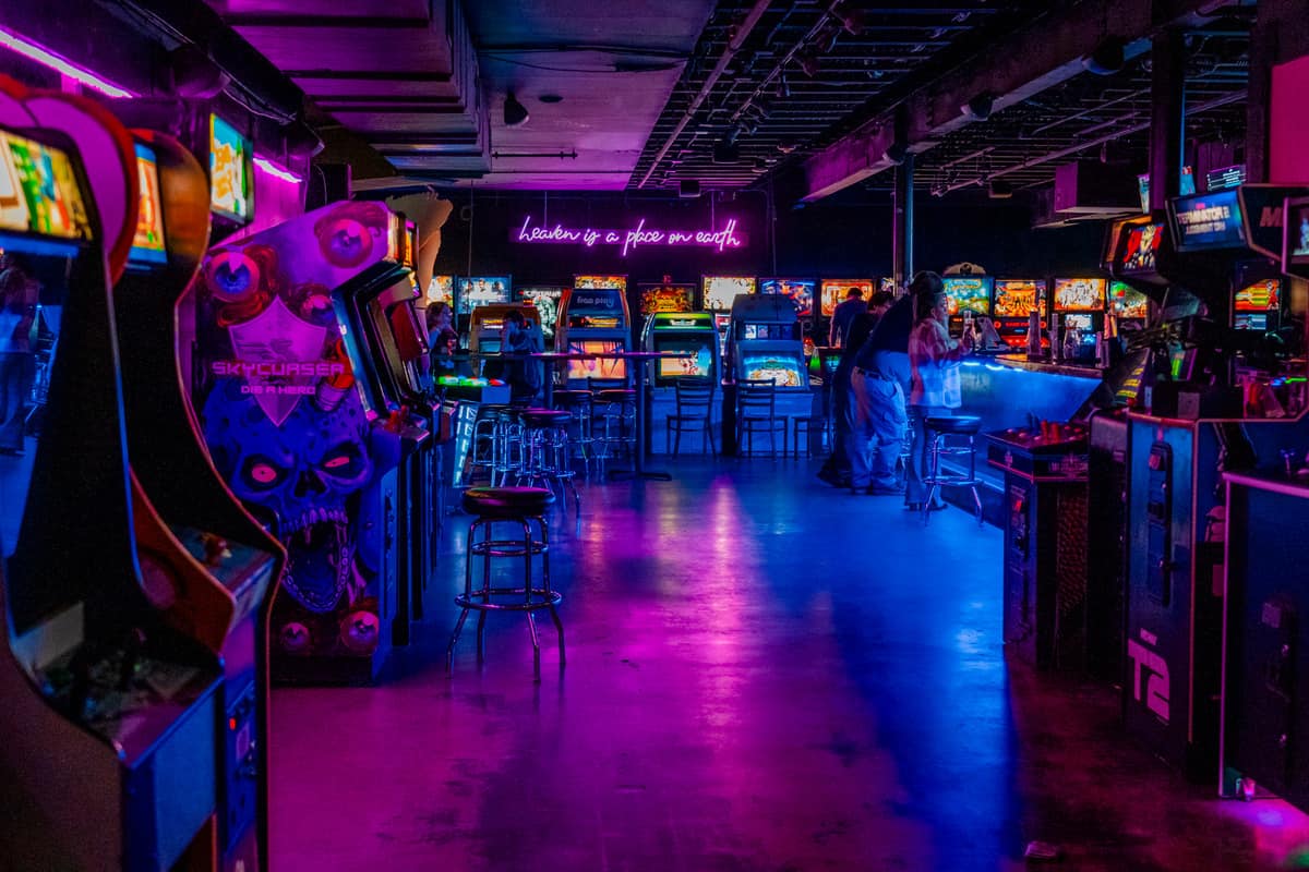 Second floor of the arcade with purple and blue neon lighting