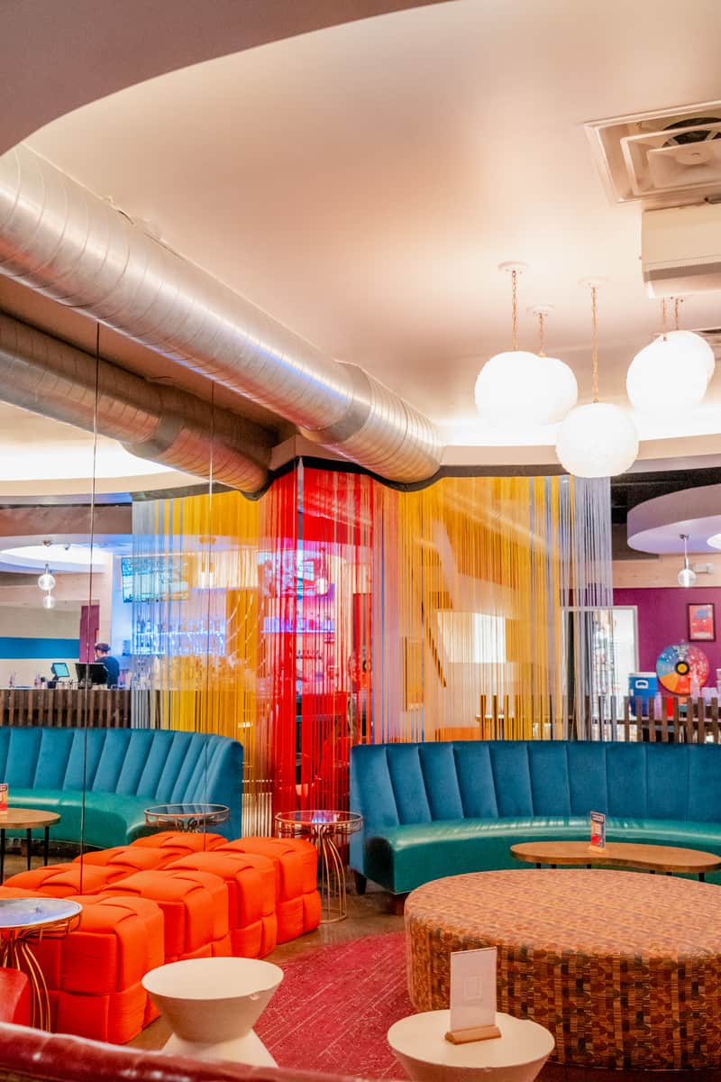 Colorful furniture and tassels hanging from the ceiling