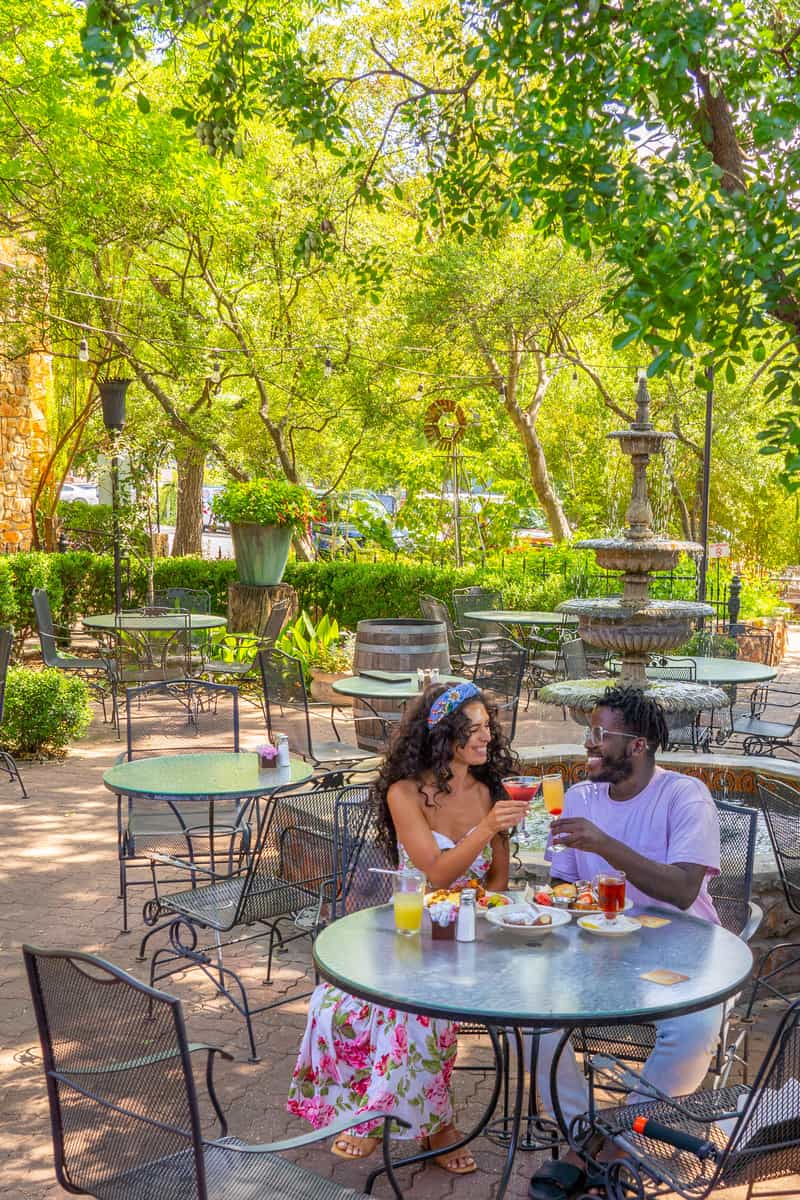 Couple sharing a meal with a cocktail in-hand