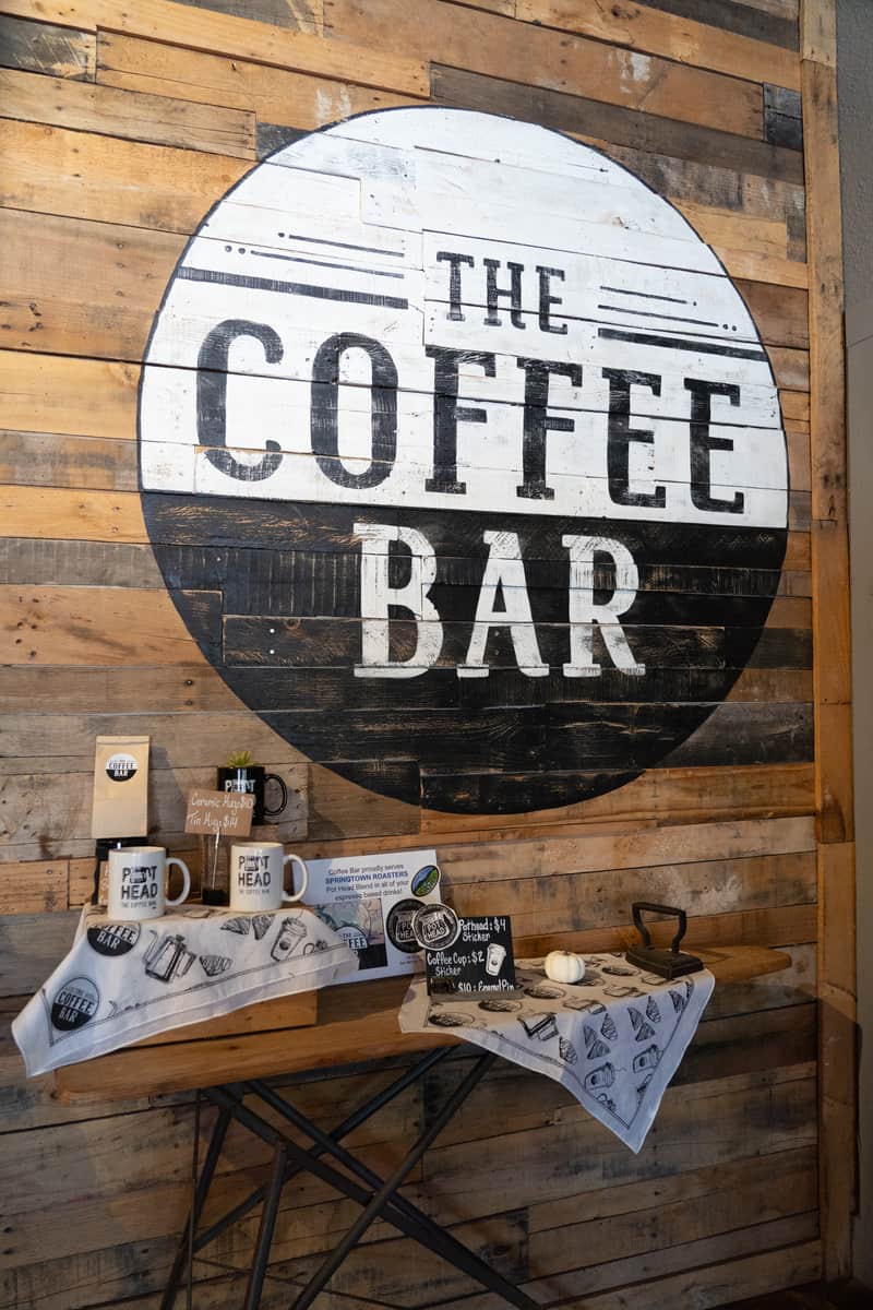 A sign painted on the wall that says "The Coffee Bar"