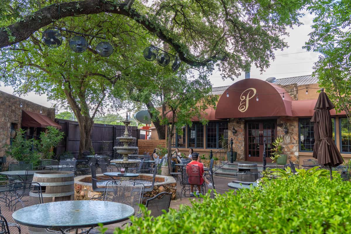 Outdoor seating with a fountain and overhanging tree