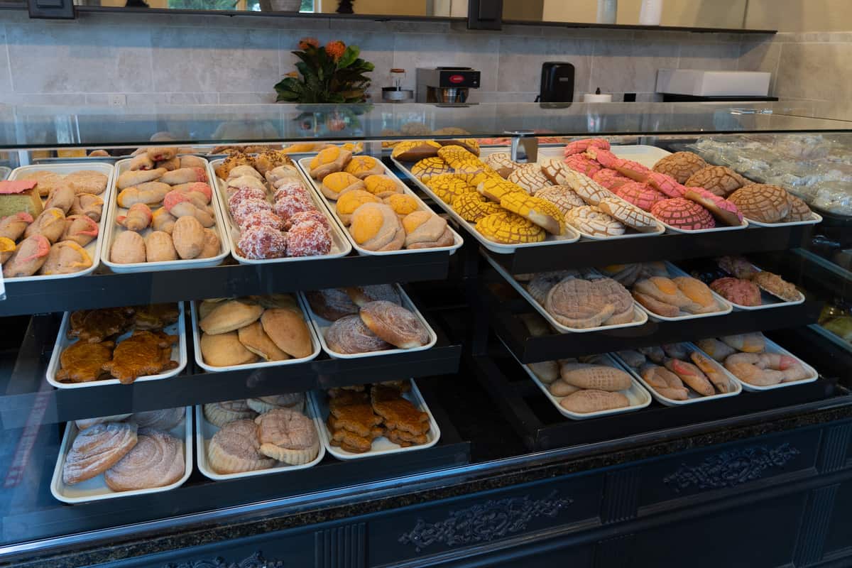 Bakery case filled with conchas and other Mexican baked goods