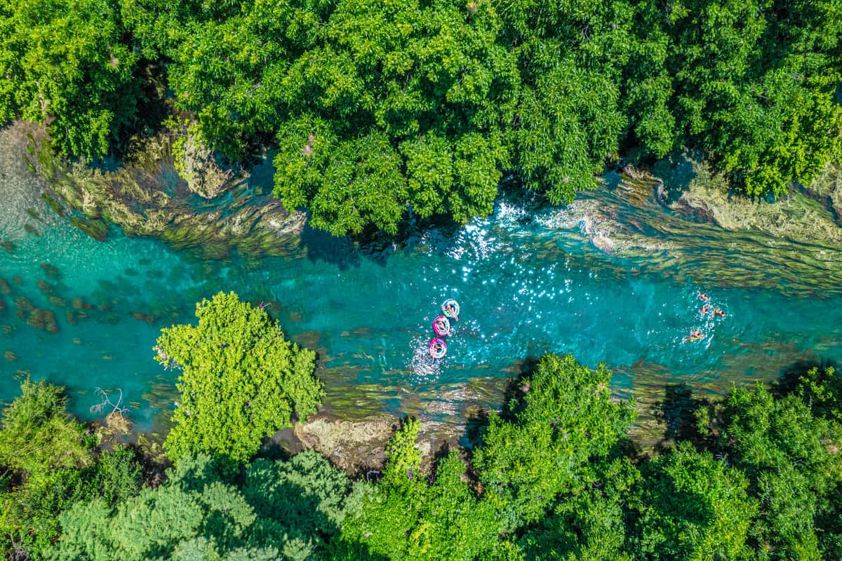 Aerial view of people on innertubes on the river