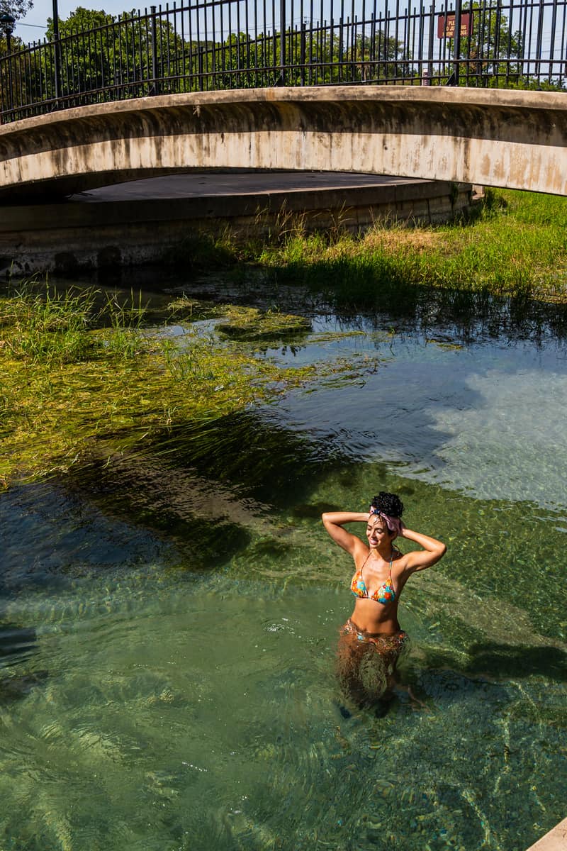 Woman standing under a bridge in the river