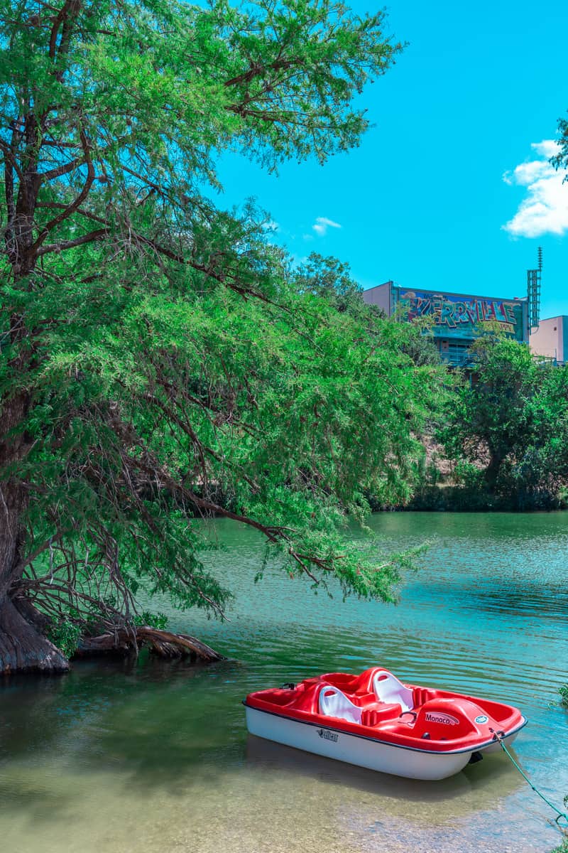 Red paddle boat on a river.