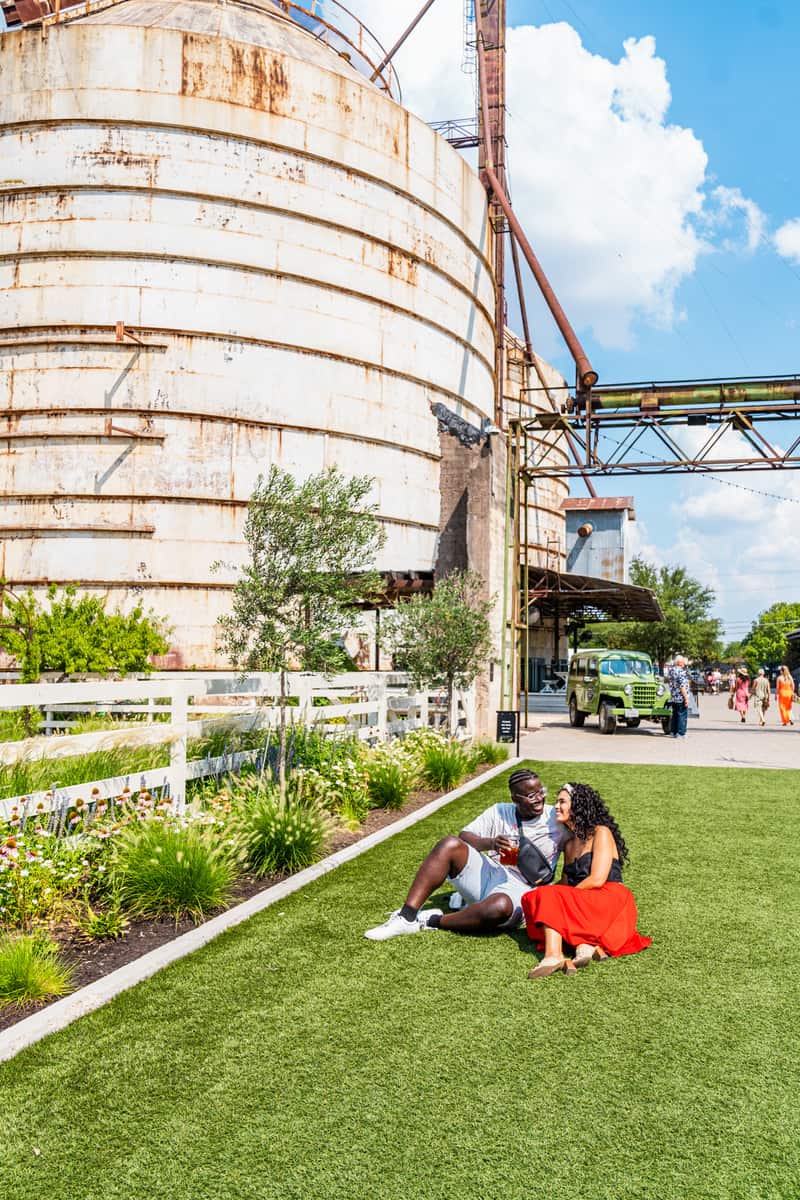 Couple sitting in the lawn of The Silos