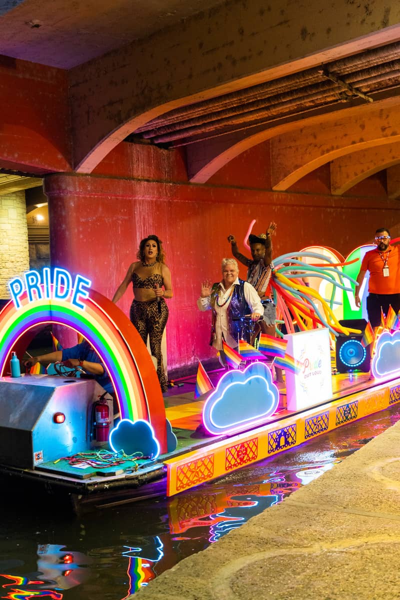 Colorful float parade on a river.