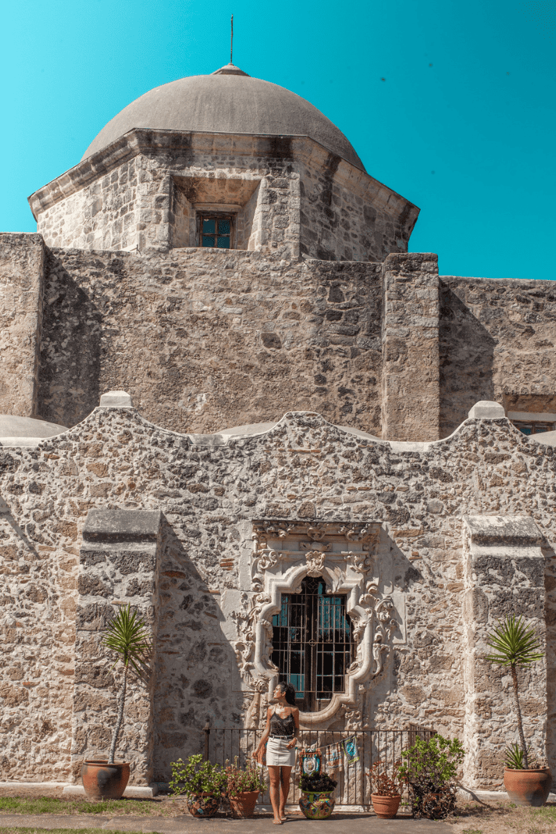 A woman outside the historical building.