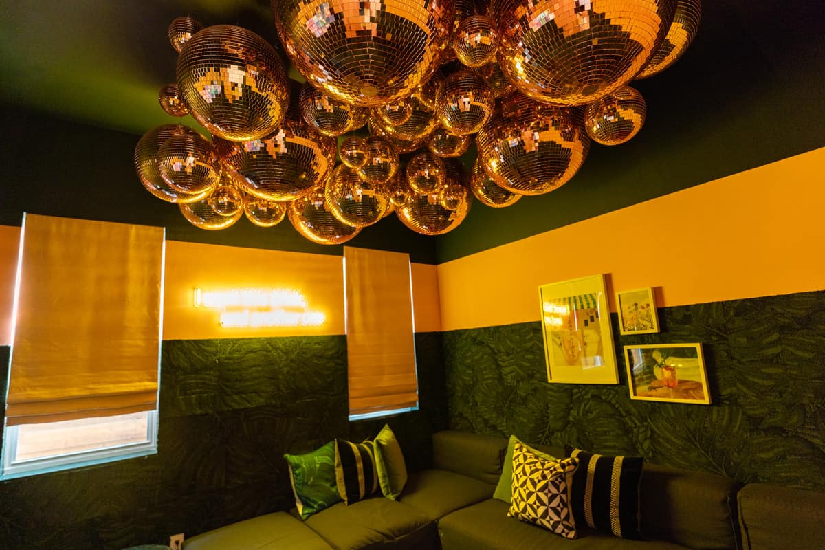 Sound-insulated karaoke room with disco balls. 