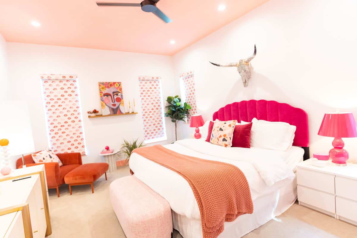 Primary room with lip-shaped window covers and glittery longhorn wall decor