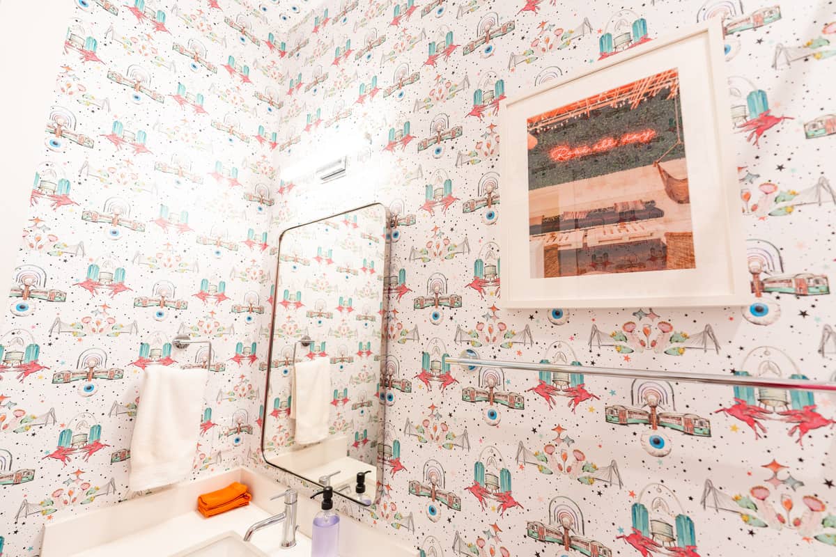 Dallas themed wallpaper in the bathroom