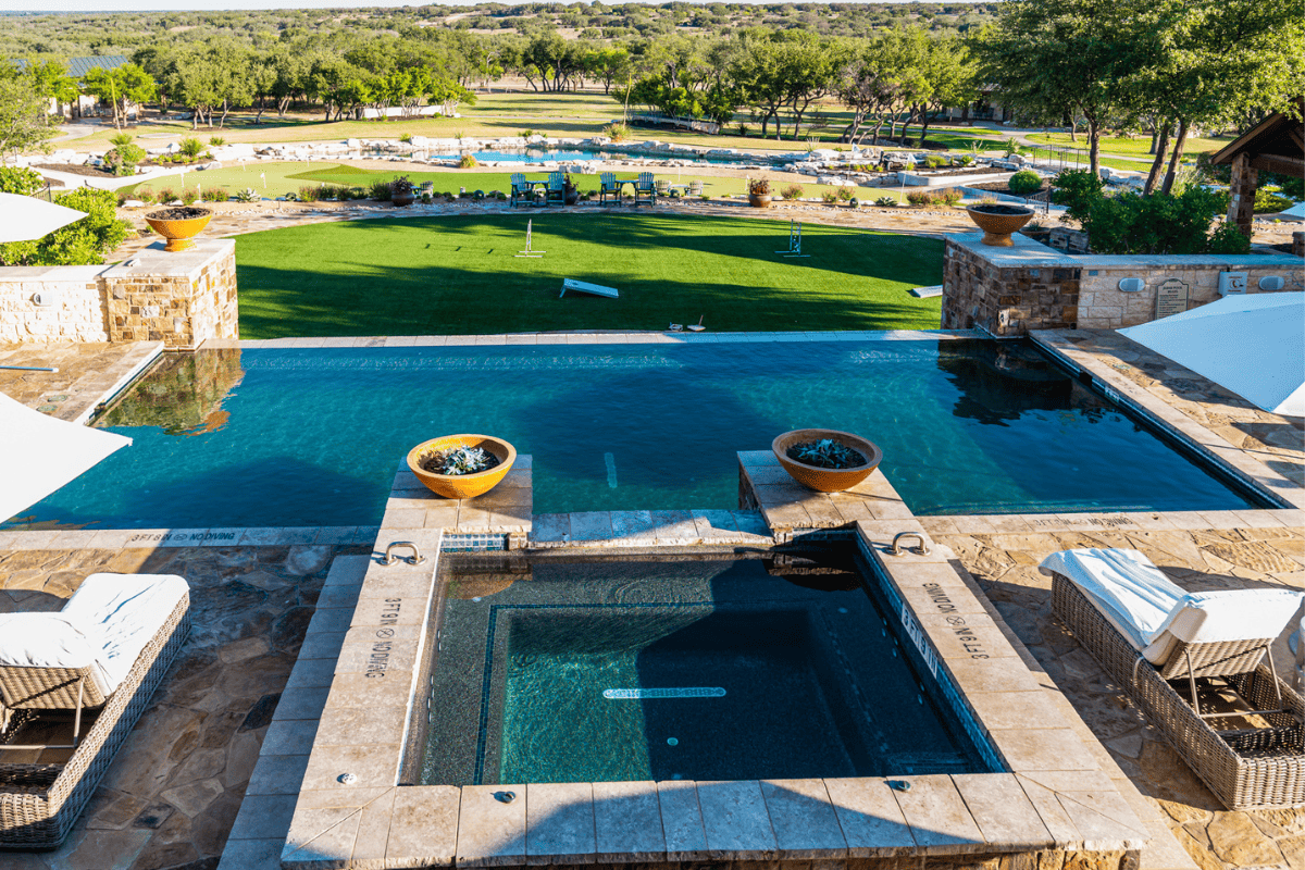 A pool with a view of the surrounding property.
