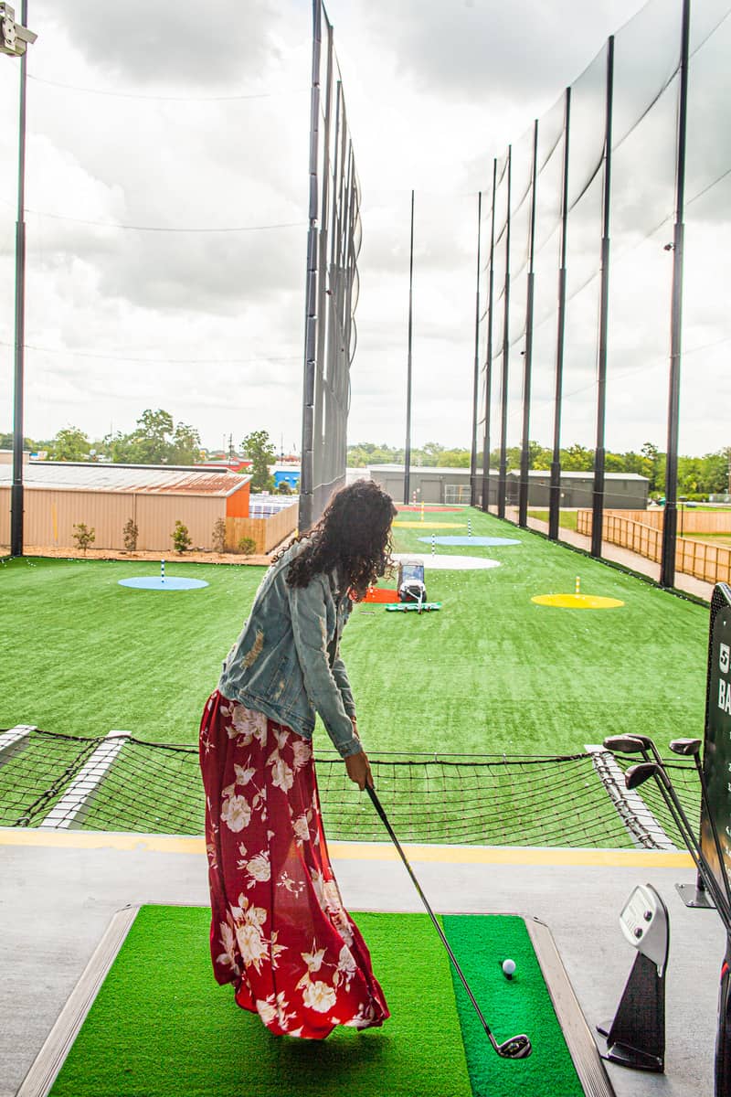 a person playing golf in a golf course