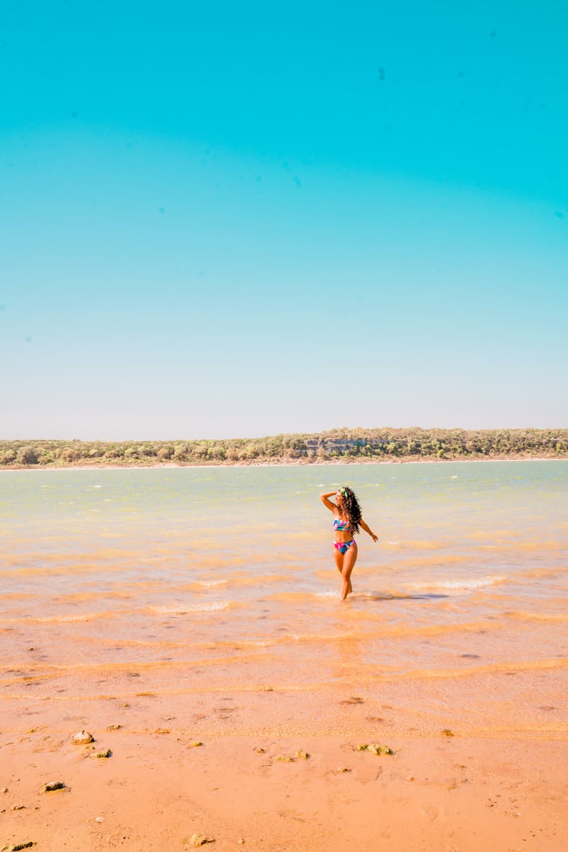 Woman walking along the beach in a bikini