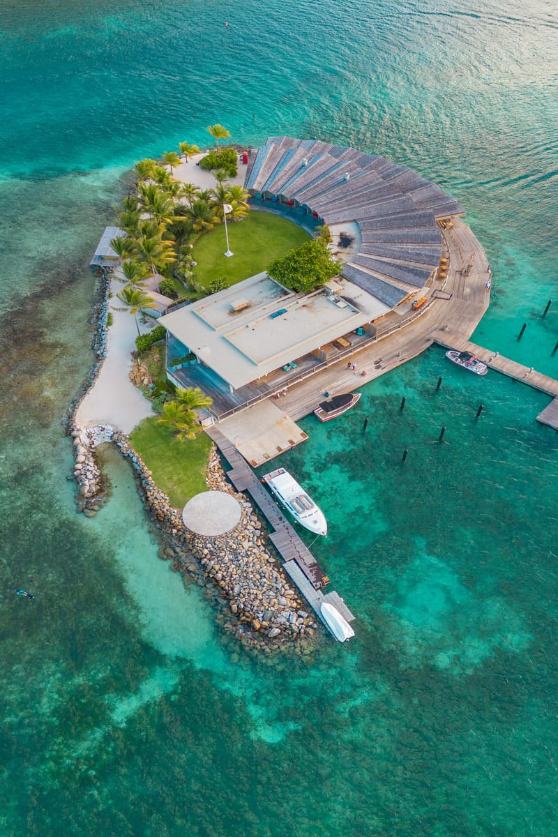 a building on an island with a dock and boats