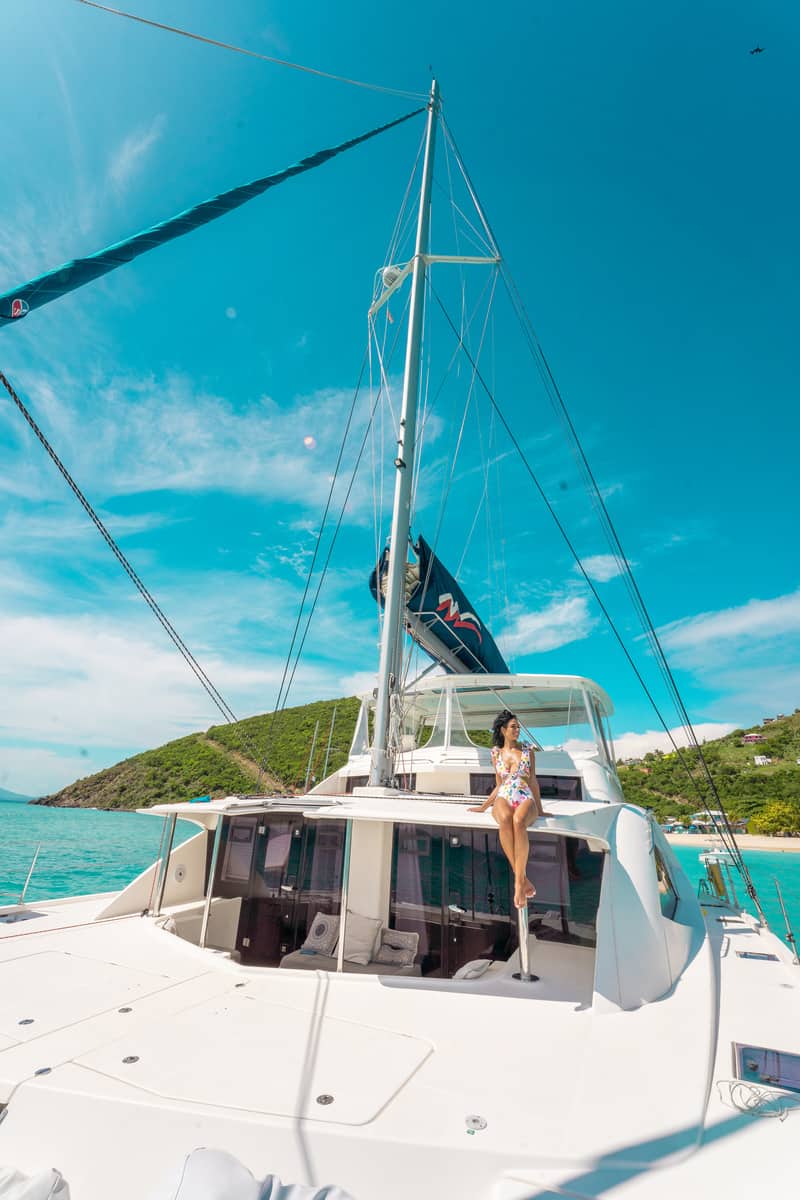 a person on a boat sailing the british virgin islands