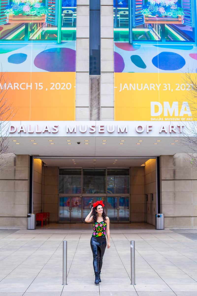 Woman in a flower crown standing in front of the Dallas Museum of Art entrance
